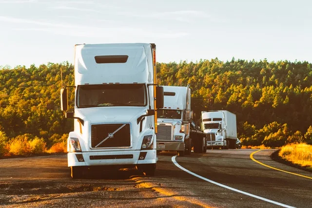 incoming insured semi trucks parked on the side of the road